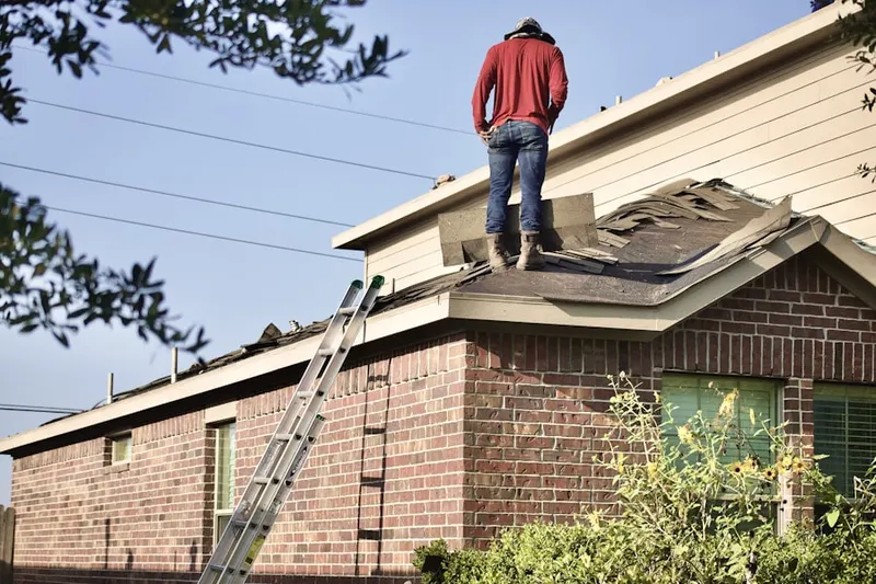 Professional roofer working on a residential roof in Broomfield Country Club